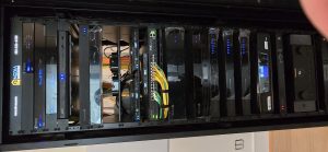 IT server rack showcasing various networking and server equipment, highlighting Minding Your Media's expertise in IT infrastructure and support services.